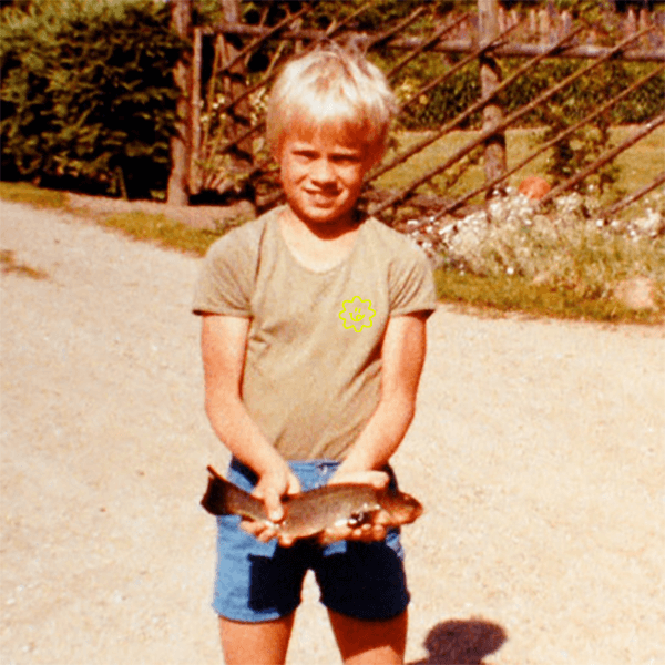 A young boy holding a fish